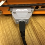This is the UC100 Parallel to USB interface installed on the parallel port with a mini USB cable that attaches to your computer. 